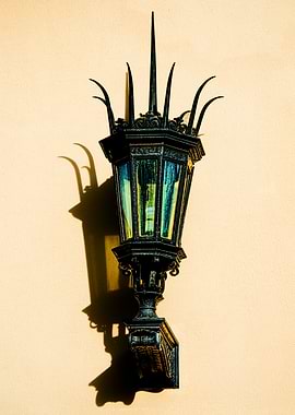 Light and Shadow, an antique gaslamp mounted on a wall ...