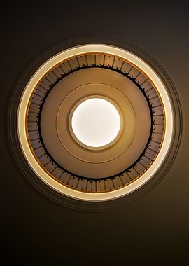 Round staircase with black handrail. View from the bott ...