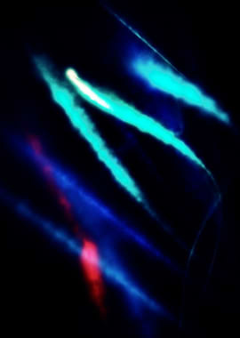 Vapour trails in blue and red dance from left to right