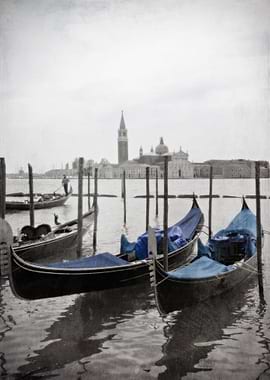 Black and white Venetian view of two blue gondolas with ...