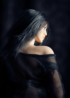 Chinese Art doll with her back to the camera looking aw ...