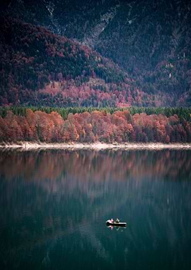 Fishing boat on lake in autum.