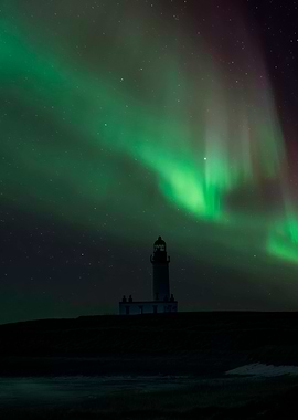 An old lighhouse and Northern Lights