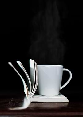 Coffee mug on white book