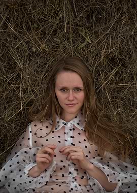 Young woman in a haystack