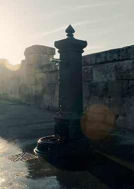 Fountain water spill sunse