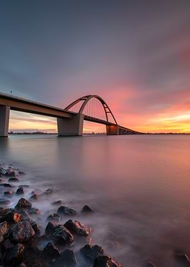 Bridge spans water sunset