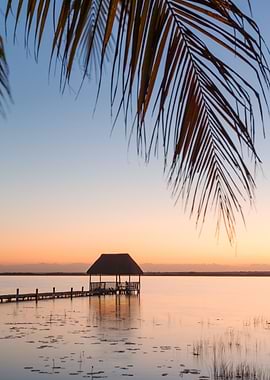 Pier and hut at sunset