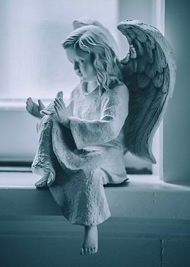 White angel on window sill