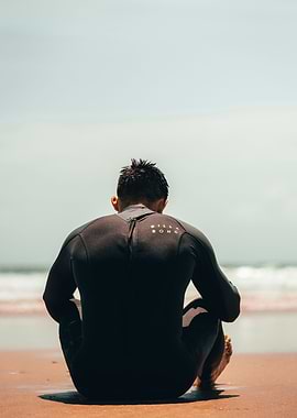 Surfer Resting on Beach