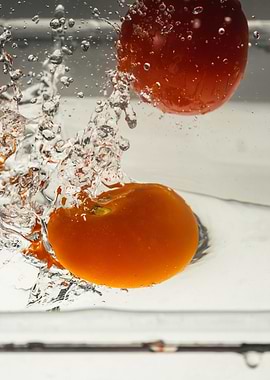 Tomatos splashing in dish