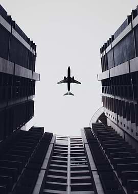 Airplane above buildings