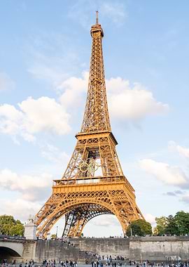 Eiffel Tower with Olympic Rings, view from Seine river on sunset.