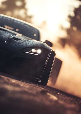 Black Sports Car speeding out of a cloud of smoke, Close-Up