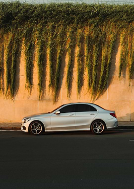 Silver Sedan Parked by Wall