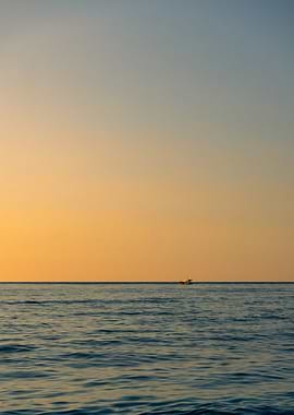 Boat on Calm Sea at Sunset