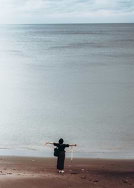 Woman on Beach with Arms Outstretched