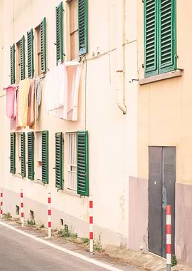 Florence, Italy I Street photography in pastel yellow summer colors in Fiesole village in Tuscany with its laundry drying in the window like la dolce vita of italian everyday daily life scene