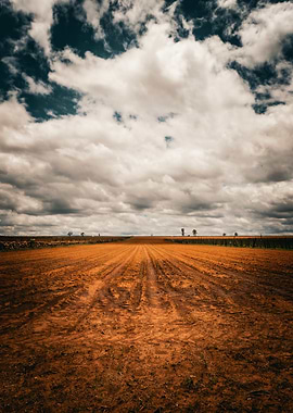 Plowed Field Under Cloudy Sky