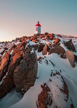 Lighthouse on Snowy Cliff