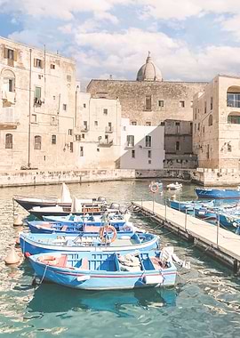 Puglia, Italy I Photography of picturesque port of Monopoli fishing village with crystal blue waters of the Mediterranean sea with its colorful barques boats and historic roman baroque architecture