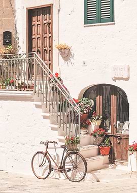 Puglia, Italy I Bicycle in front of flower house in white village of Ostuni in Italian countryside authentic retro vintage minimalist aesthetic in pastel Mediterranean summer colors during sunrise