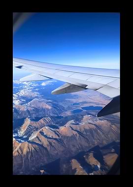 Airplane Wing Over Mountains