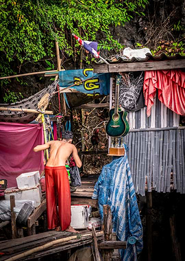 Man in Red Pants by a Hut