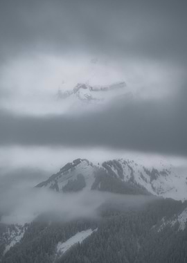 Snowy Mountain Peaks in Fog