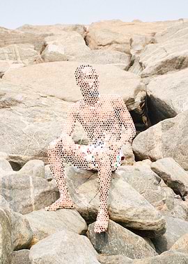 Man Sitting on Rocks