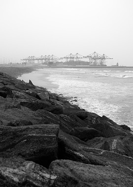 Harbor Cranes and Rocky Shore