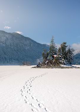 Cabin on frozen lake