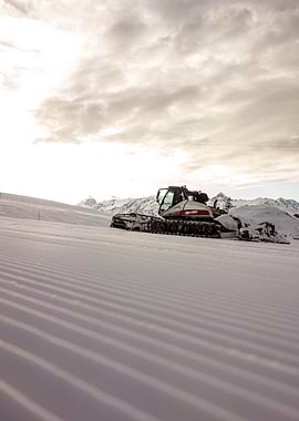 Snowcat on Mountain Slope