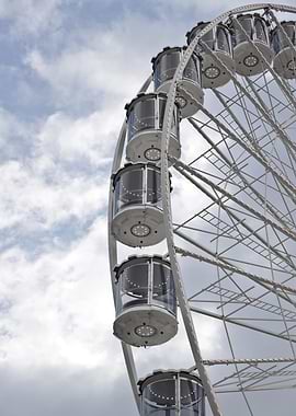 Ferris Wheel Against Cloudy Sky