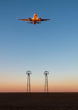 Airplane Landing at Sunset