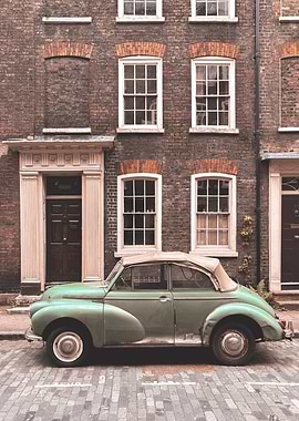 London, England I Vintage retro car on a street with urban industrial architecture and brick facade with the nostalgic aesthetic of a picturesque authentic British street urban city landscape