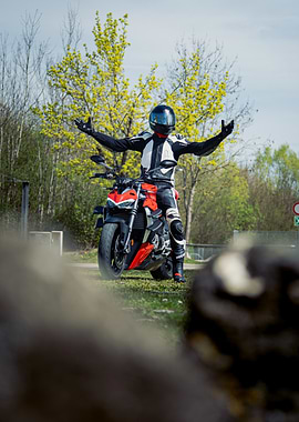 Motorcyclist with Arms Outstretched