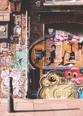 London, England I Shoreditch's colorful brick wall with street art and creative design graffiti mural at sunrise light on a Londoner street with an industrial aesthetic urban ambience cityscape