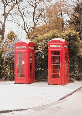 London, England I Iconic vibrant red British telephone boxes in Primrose Hill londoner district street photography of an urban scene in a natural park with autumn pastel retro vintage aesthetic