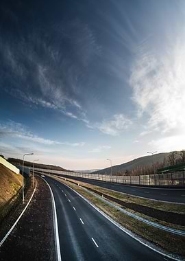 Empty Highway Under Blue Sky