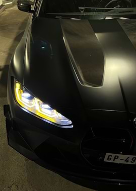 Black BMW M4 with Yellow Headlights