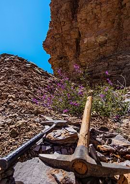 Geologic hammer, pickaxe, and blue sky on the field