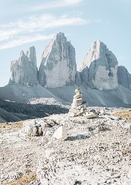 Dolomites, Italy I Tre Cime di Lavaredo mountain landscape with cairn in foreground and rocky peaks the authentic, geometric, raw mineral wilderness nature of the Italian Alps during summer