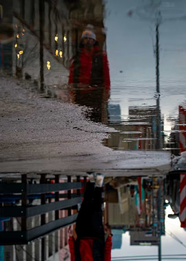 Urban Reflection: Person in Puddle