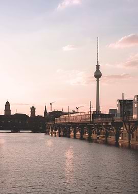 Berlin, Germany I Poetic silhouette of Berlin skyline with Fernsehturm tower at sunset in pastel pink and blue tones photography, reflected in the Spree River for a romantic and minimal urban mood