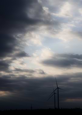 Wind Turbines Under Cloudy Sky