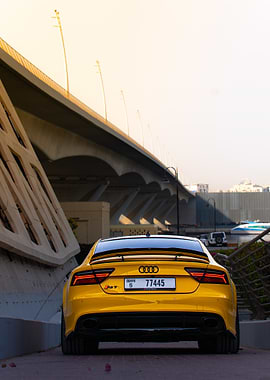 Yellow Audi RS7 under a bridge