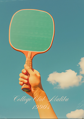 Hand holding paddle against blue sky