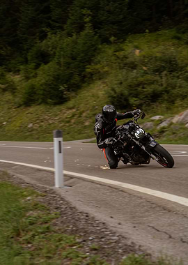Motorcycle rider cornering on mountain road