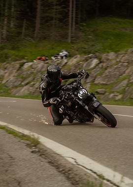 Motorcycle rider cornering on mountain road